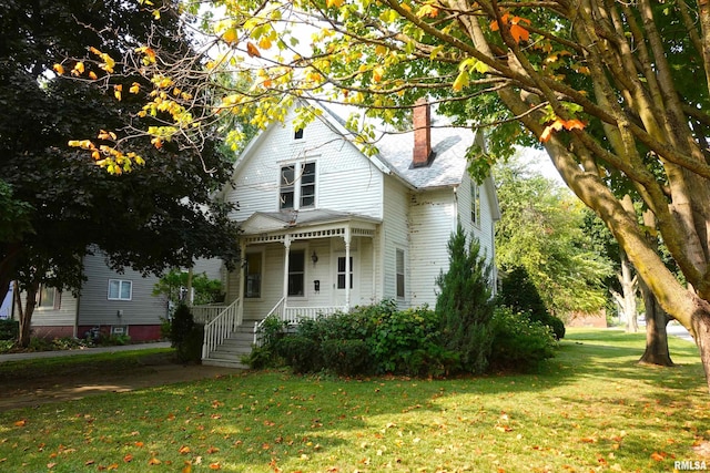 view of front of house with covered porch and a front yard