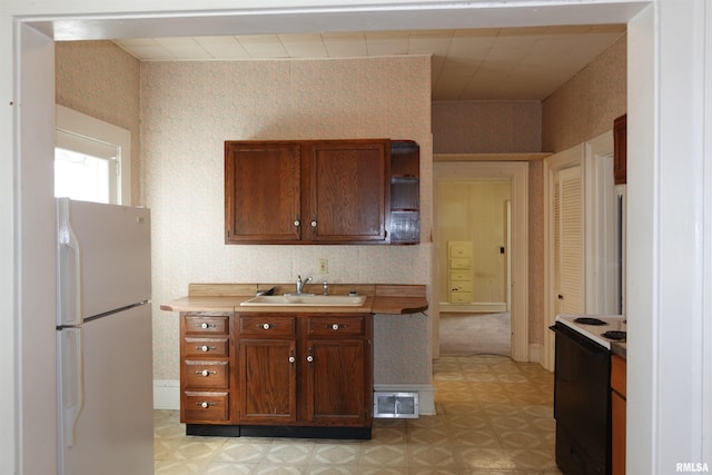 kitchen featuring white appliances and sink