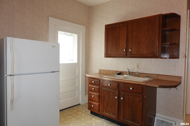 kitchen with sink and white refrigerator