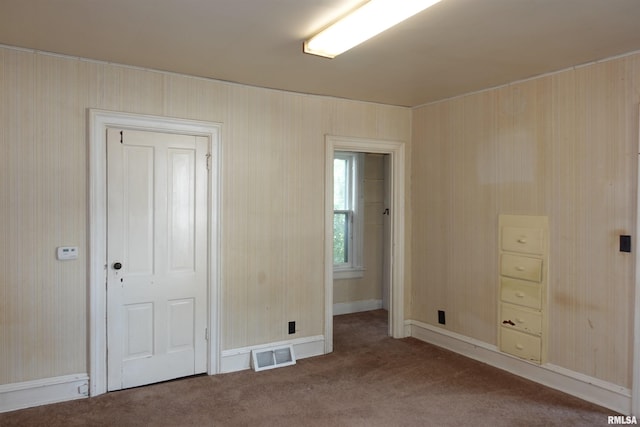 unfurnished bedroom featuring carpet and a closet