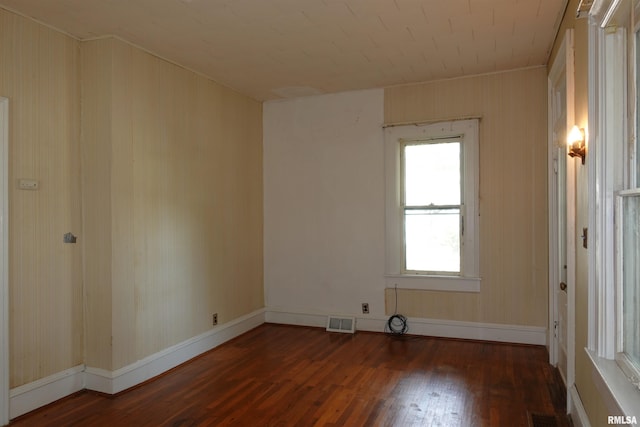 spare room featuring dark wood-type flooring