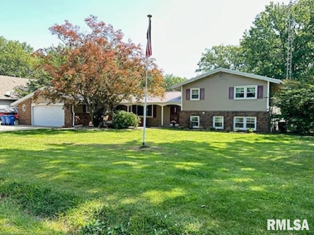 tri-level home with a front yard and a garage