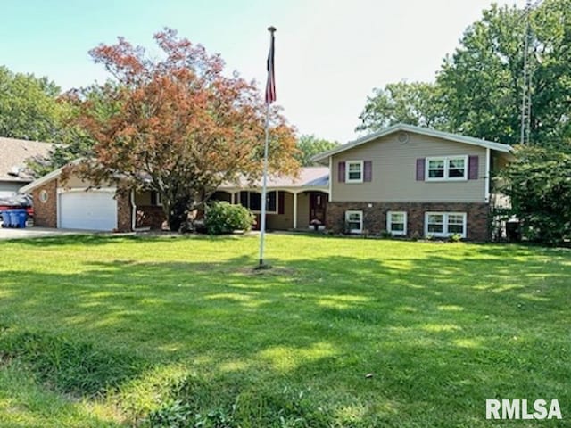 tri-level home with an attached garage and a front lawn