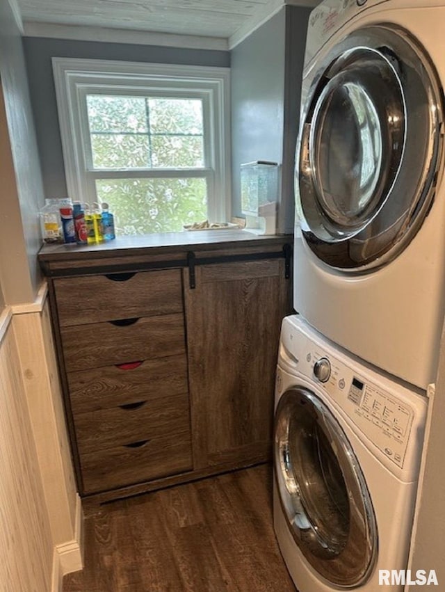 laundry area with dark wood-style floors, laundry area, stacked washing maching and dryer, and ornamental molding