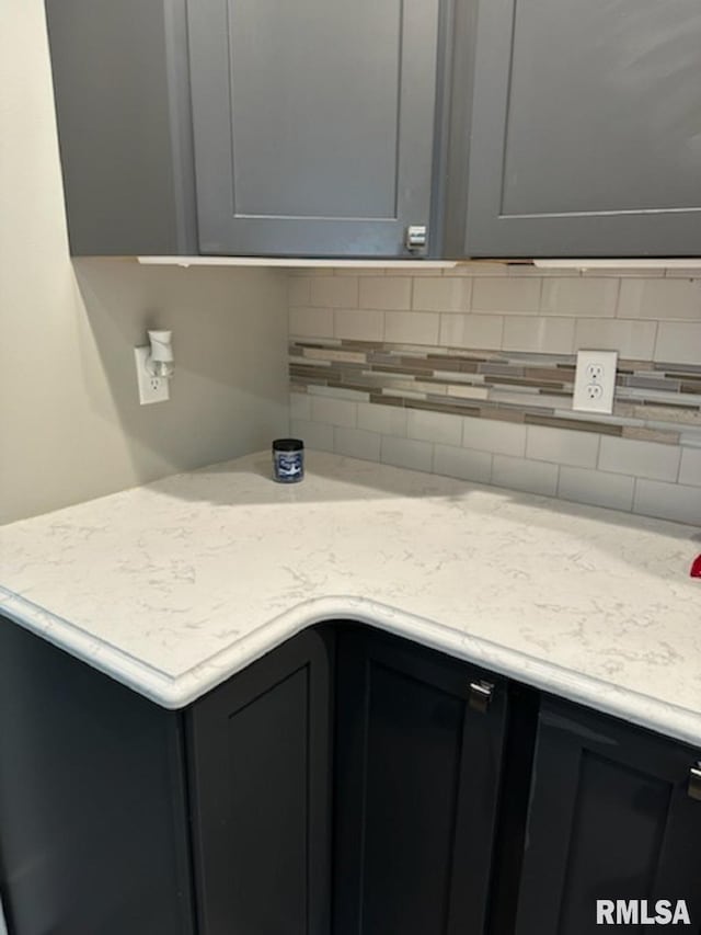 kitchen featuring decorative backsplash and gray cabinets