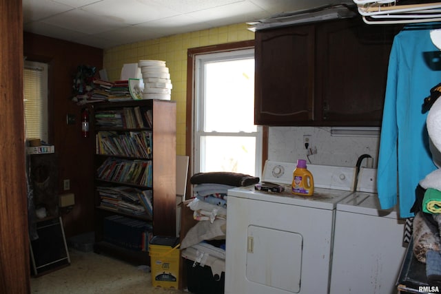 laundry area with cabinets and washer and clothes dryer