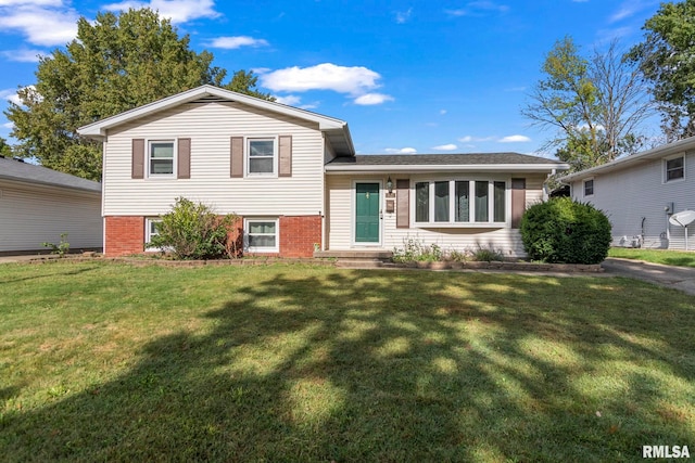 tri-level home with a front yard