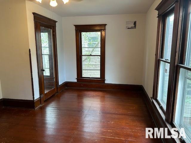 spare room featuring ceiling fan and dark hardwood / wood-style floors