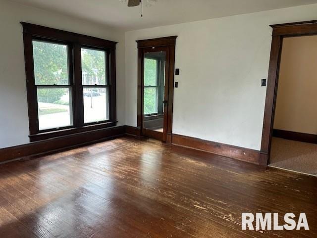 spare room featuring ceiling fan and dark hardwood / wood-style flooring