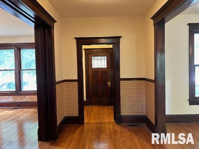 corridor with hardwood / wood-style flooring