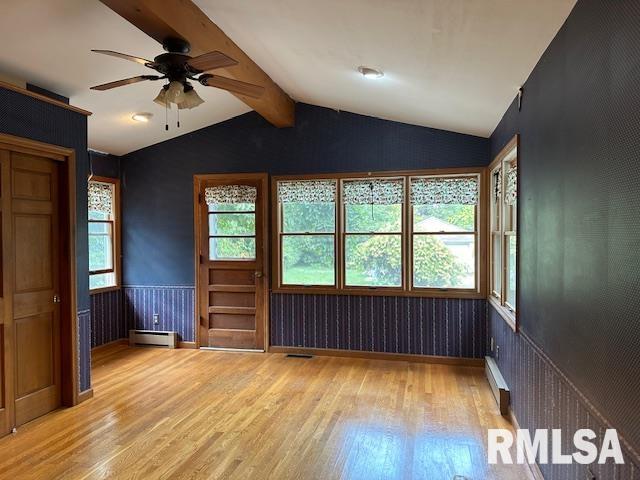 empty room with a baseboard radiator, ceiling fan, vaulted ceiling with beams, and light hardwood / wood-style floors