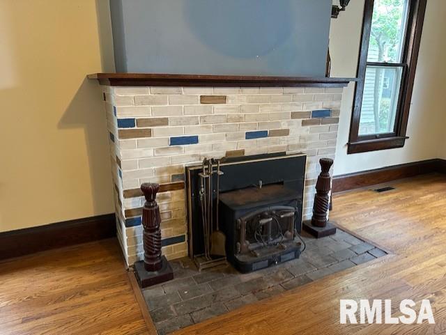 details with a fireplace and hardwood / wood-style flooring