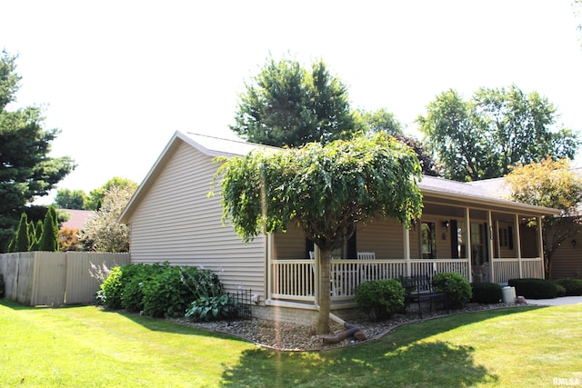 view of home's exterior with a porch and a yard