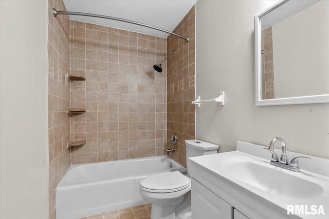 full bathroom with tile patterned flooring, toilet, vanity, and tiled shower / bath