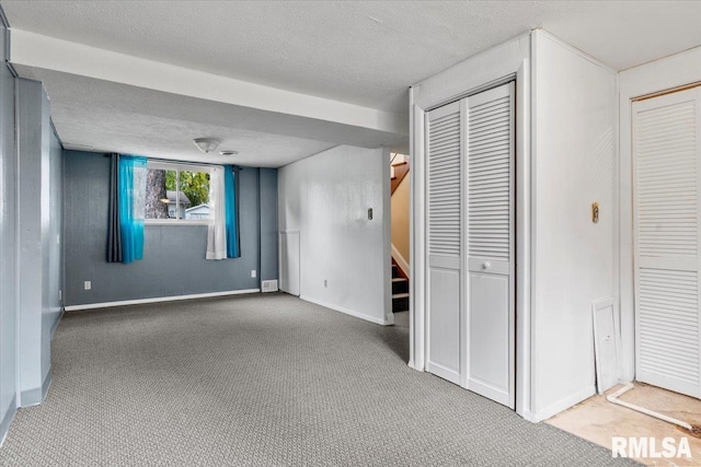 interior space with carpet flooring and a textured ceiling