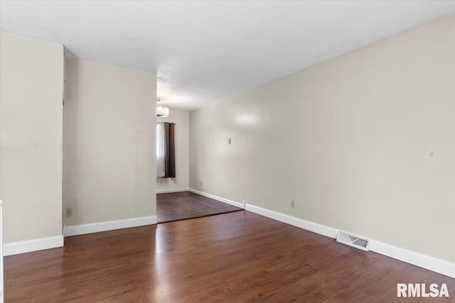 spare room featuring dark hardwood / wood-style flooring