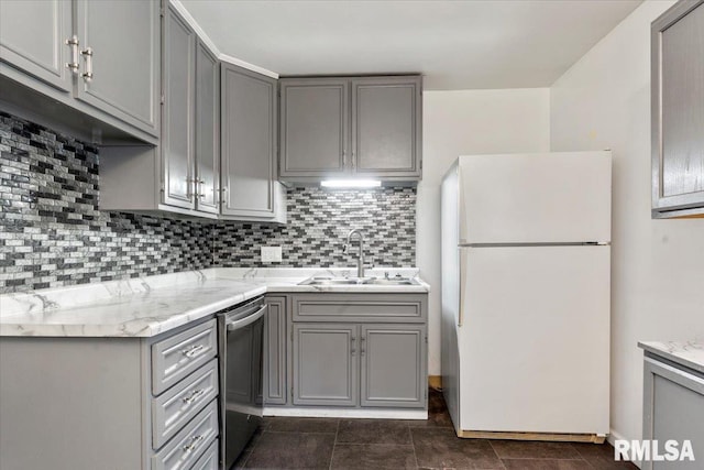 kitchen with white fridge, gray cabinets, and sink