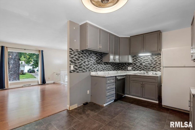 kitchen with gray cabinets, dishwasher, white fridge, and sink