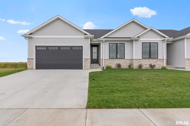 view of front of property with a garage and a front lawn