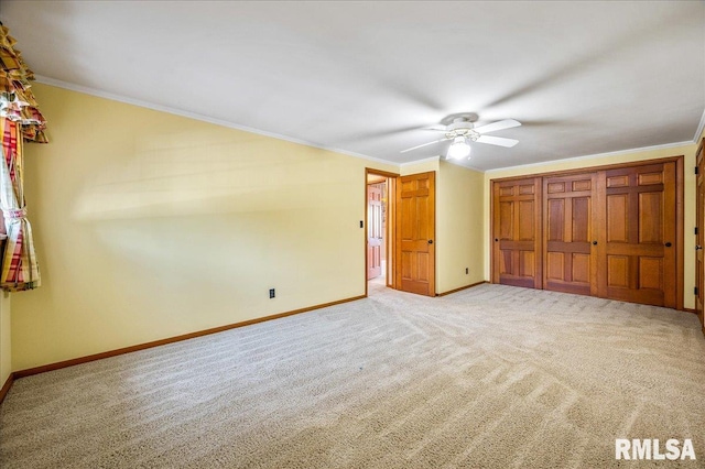 unfurnished bedroom with ornamental molding, light colored carpet, and ceiling fan