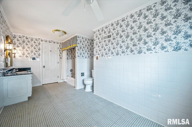 full bathroom with shower / bath combo, toilet, tile walls, vanity, and ornamental molding