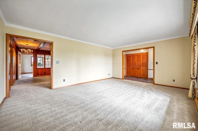 unfurnished room with ornamental molding, a notable chandelier, and carpet floors