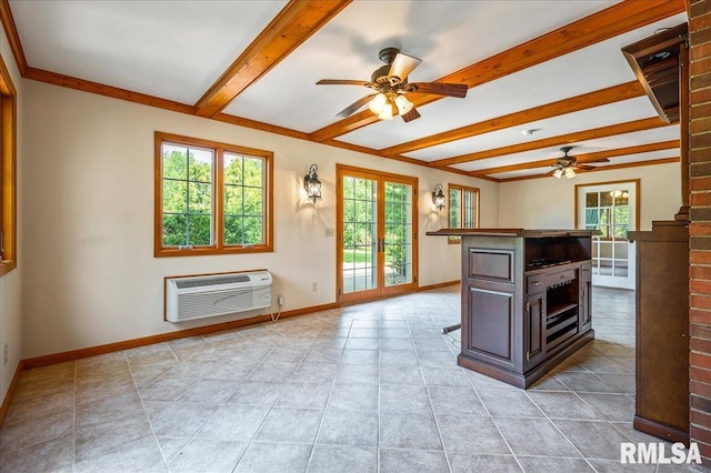 interior space featuring beamed ceiling, a wealth of natural light, a kitchen island, and ceiling fan