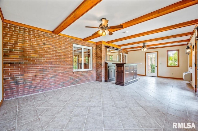 unfurnished living room with brick wall, ceiling fan, light tile patterned floors, and beam ceiling