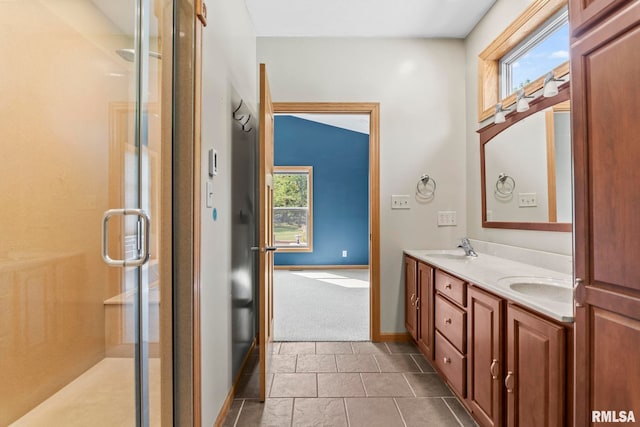 bathroom with tile patterned floors, a shower with shower door, and vanity