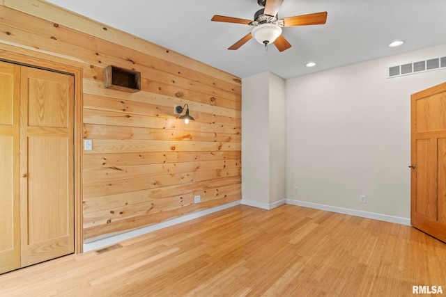 empty room with wood-type flooring and ceiling fan