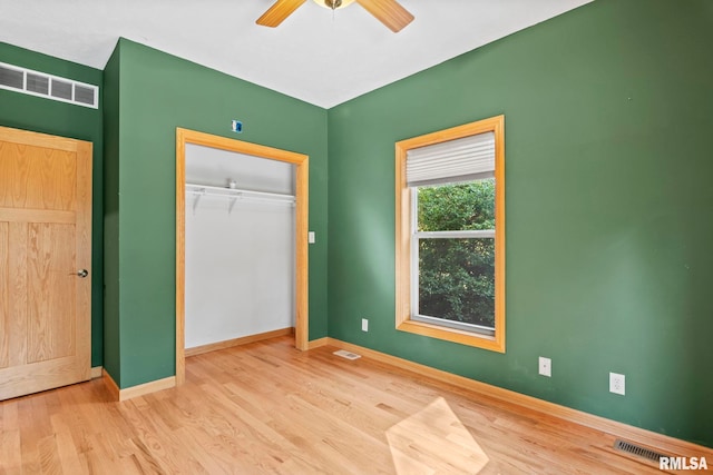 unfurnished bedroom featuring ceiling fan, a closet, and light hardwood / wood-style flooring