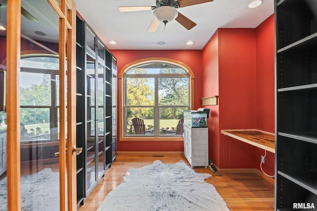 interior space with french doors, light wood-type flooring, and ceiling fan