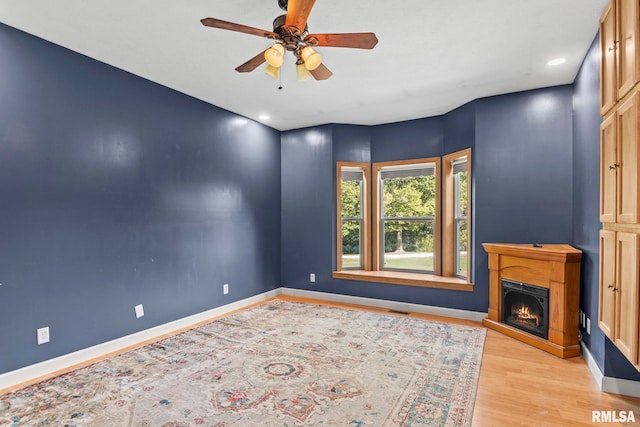 interior space with light hardwood / wood-style flooring and ceiling fan