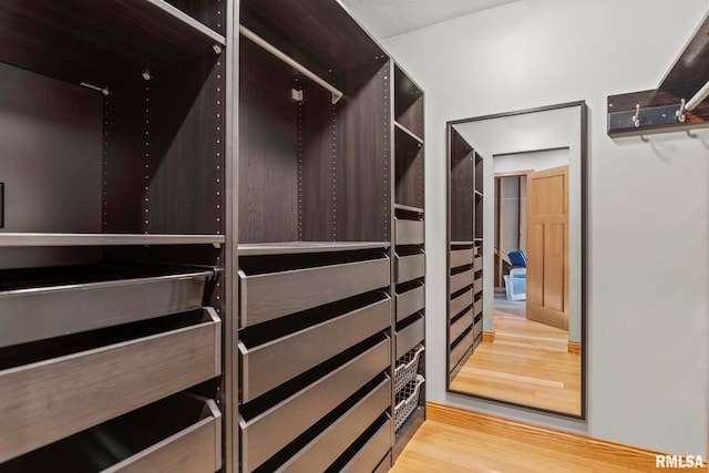 spacious closet featuring light hardwood / wood-style floors