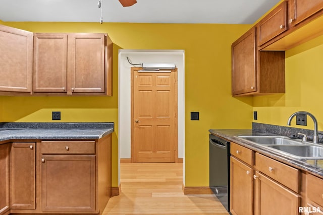 kitchen featuring black dishwasher, sink, ceiling fan, and light hardwood / wood-style flooring