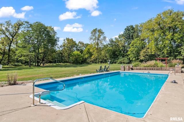 view of pool featuring a patio and a yard