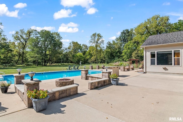 view of pool featuring a lawn, a patio, and an outdoor fire pit