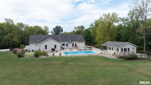 rear view of house with a patio, a yard, and an outdoor structure