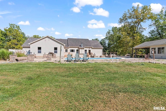 back of house featuring a lawn and a patio area