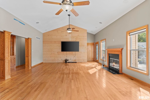 unfurnished living room featuring light hardwood / wood-style floors, ceiling fan, and vaulted ceiling