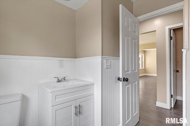 bathroom with vanity, hardwood / wood-style floors, and toilet