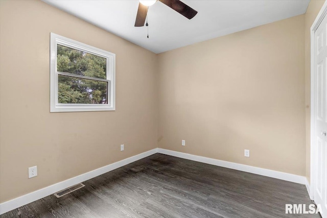 empty room with ceiling fan and dark hardwood / wood-style flooring