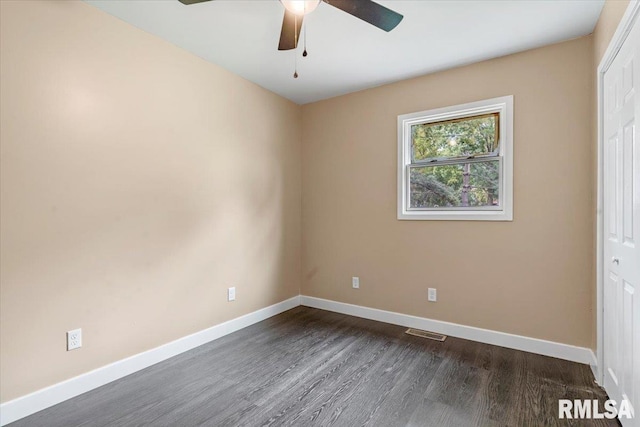 spare room featuring ceiling fan and dark wood-type flooring