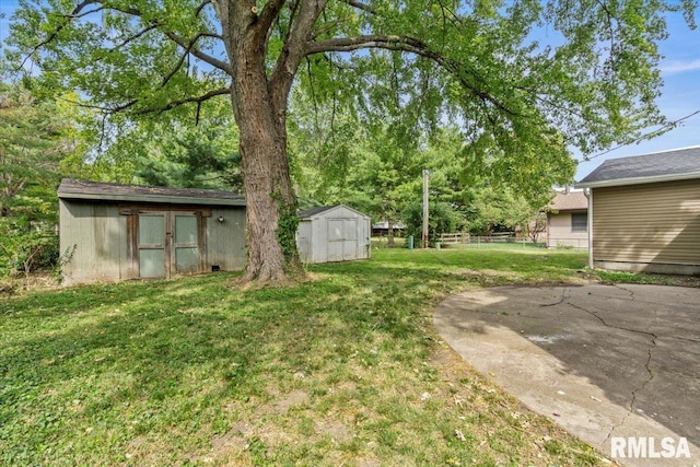 view of yard with a storage unit and a patio area