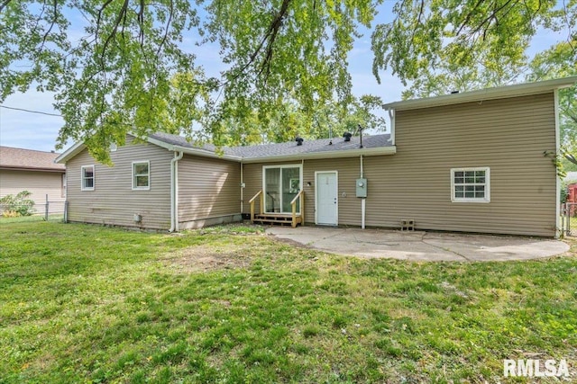 back of property featuring a lawn and a patio area