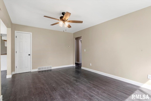 spare room featuring ceiling fan and dark wood-type flooring