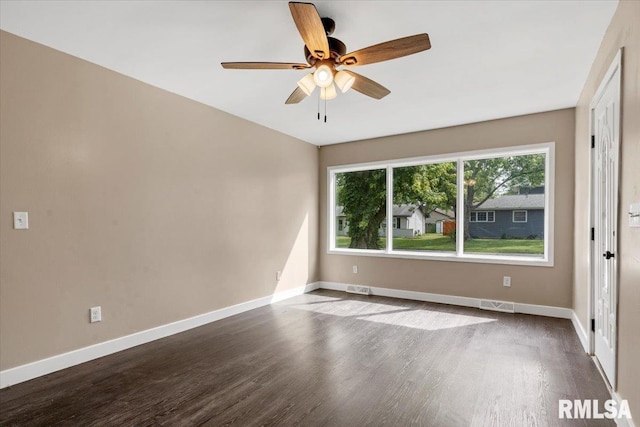 empty room with ceiling fan and dark wood-type flooring