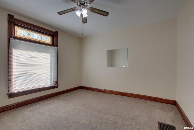 spare room with ceiling fan and carpet flooring