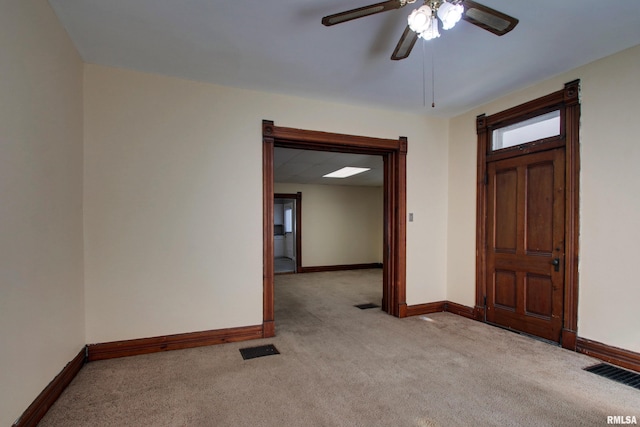 entryway featuring ceiling fan and light colored carpet