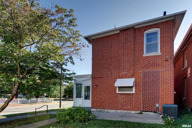 back of house with central air condition unit